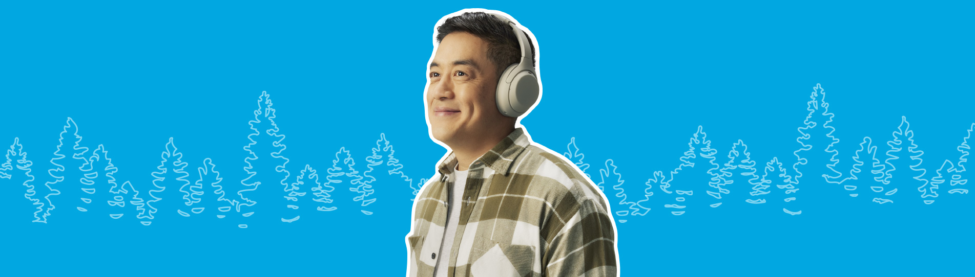 smiling man walking listening to his playlist with headphones on